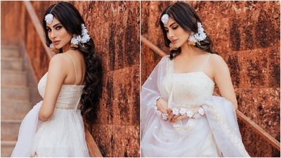 Mouni teamed the suit with matching bottoms and pristine white zari dupatta featuring gotta patti borders and gold brocade embellishments. The star opted for floral jewellery pieces with the ethnic ensemble, adding a dreamy touch to her Haldi look. She wore white flower haath phool, matching maang tika, and gold earrings adorned with floral adornments attached to her hair. (Instagram/@imouniroy)
