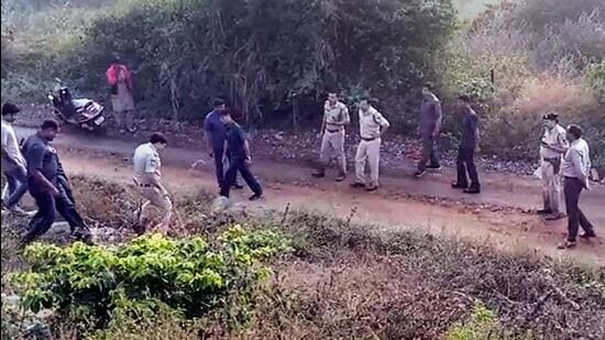 Telangana police officers at the site of an alleged encounter, where four accused in the rape and murder of a veterinary were shot dead, on the outskirts of Hyderabad on Dec 6, 2019. (PTI)