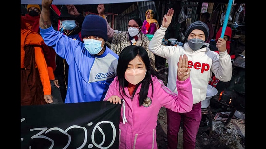 Youth activists flash the three-finger protest gesture during an anti-military government protest rally, February 1, 2022, Mandalay, Myanmar (AP)