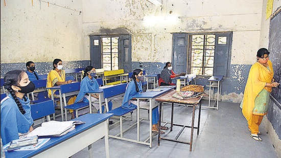 Students follow Covid-19 protocols while attending a class at Government High school, at Musheerabad, in Hyderabad on Tuesday. (ANI)