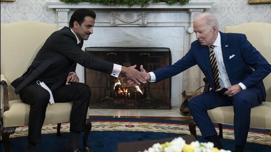 US President Joe Biden (right) shakes hands with the Qatar's Emir Sheikh Tamim Al Thani in the Oval Office of the White House on Monday. (AP)