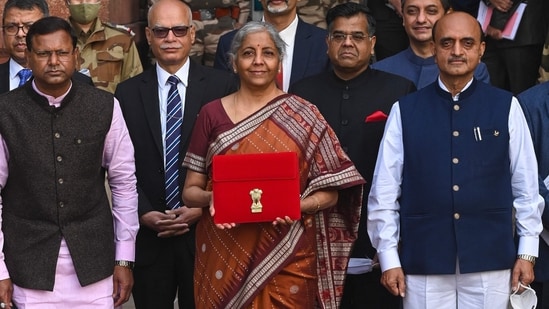 India's Finance Minister Nirmala Sitharaman carrying a bag leaves the ministry of finance to present the annual budget at the parliament in New Delhi.(AFP)