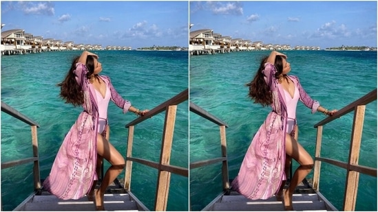 Malavika styled the beach outfit with statement rose-shaped gold earrings, layered bracelets, and a gold anklet. Her glam picks include open locks, mauve-toned lip shade, blushed cheeks, and mascara-adorned lashes.(Instagram/@malavikamohanan_)