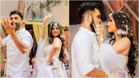 Mouni's husband Suraj Nambiar also looked dapper for the Haldi. He complemented his wife in an all-white ensemble. He chose a collared button-down white shirt adorned with stripes and teamed it with white straight fit pants. Suraj rounded off his Haldi look with a side-swept hairdo and a well-groomed beard.(Instagram/@imouniroy)