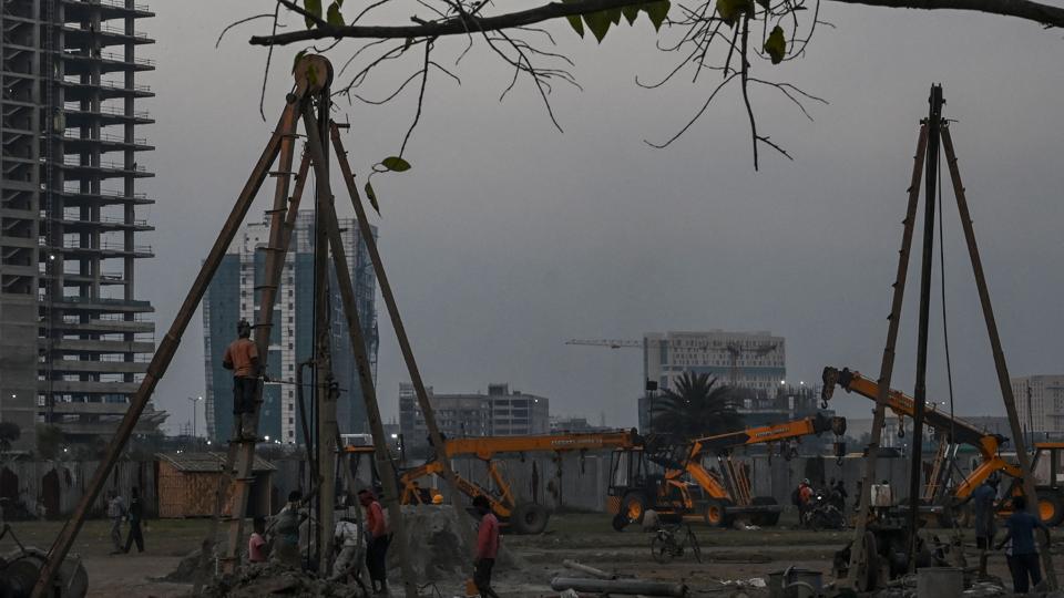 Construction workers work at an under construction commercial building in Kolkata. (AFP) Construction workers work at an under construction commercial building in Kolkata. (AFP)