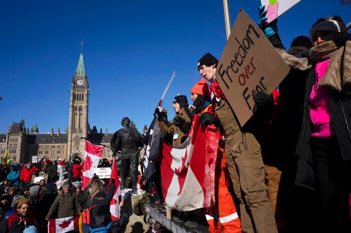 Protesters participating in a cross-country truck convoy protesting measures taken by authorities to curb the spread of Covid-19 and vaccine mandates gather near Parliament Hill in Ottawa on Saturday. (AP) Protesters participating in a cross-country truck convoy protesting measures taken by authorities to curb the spread of Covid-19 and vaccine mandates gather near Parliament Hill in Ottawa on Saturday. (AP)