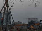 Construction workers work at an under construction commercial building in Kolkata. (AFP)
