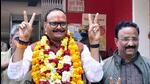 Uttar Pradesh law minister Brajesh (wearing garland) flashes the victory sign before filing his nomination in Lucknow on Wednesday. (ANI PHOTO)