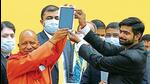 Chief minister Yogi Adityanath hands over a tablet to a student at a distribution programme in Lucknow. (FILE PHOTO)