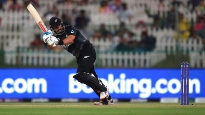 New Zealand's batsman Daryl Mitchell watches his shot during the Cricket Twenty20 World Cup semi-final match between England and New Zealand in Abu Dhabi. (AP)