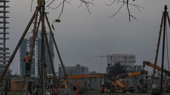 Construction workers work at an under construction commercial building in Kolkata. (AFP) Construction workers work at an under construction commercial building in Kolkata. (AFP)