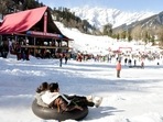 Tourists enjoy at a ski centre after the snowfall in Himachal Pradesh's Manali on Monday. (ANI Photo) Tourists enjoy at a ski centre after the snowfall in Himachal Pradesh's Manali on Monday. (ANI Photo)