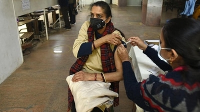 A senior citizen gets a booster dose of Covid-19 vaccine at the district hospital in Noida’s Sector 30 on Tuesday. (Sunil Ghosh /HT)