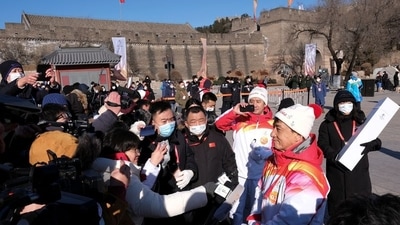 "I woke up at 4 a.m. This is my fourth Olympics. I'm very happy. I'm also cold!", Jackie Chan told reporters after his run along the wall. (REUTERS)