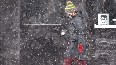 A woman walks through the snow in Chicago, Illinois. (AFP) A woman walks through the snow in Chicago, Illinois. (AFP)