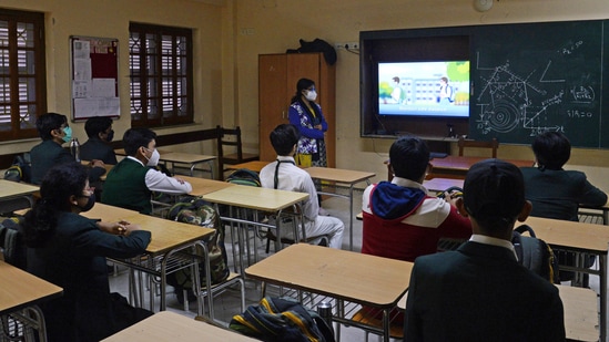 Students of Delhi Public School (DPS), Kolkata watch a Covid-19 protocol animation video during a class as the West Bengal Government reopens schools for classes 8 to 12.(ANI)