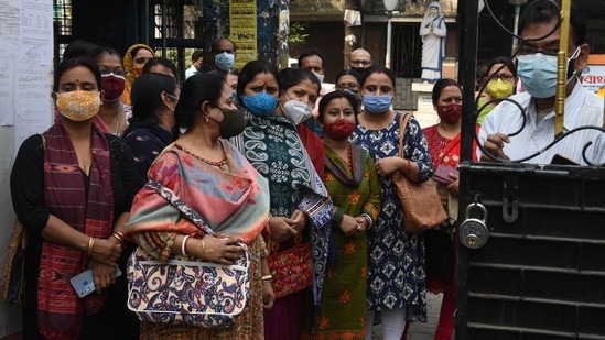 Parents eagerly wait for their children outside the premises of Scottish Church Collegiate School Kolkata, West Bengal.(HT Photo/Samir Jana)