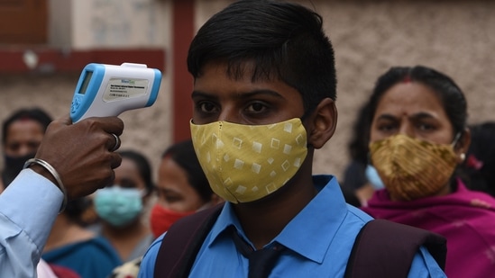 A student undergoes thermal screening at Scottish Church Collegiate School in Kolkata, West Bengal. (HT Photo/Samir Jana)