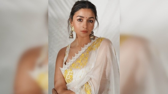 Ahead of the trailer launch of her film Gangubai Kathiawadi, Alia Bhatt stepped out looking radiant and elegant in a white organza saree which she teamed with a sleeveless backless sequins blouse.(Devnaagri)