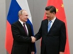 Russian president Vladimir Putin (L) shakes hands with Chinese president Xi Jinping during an earlier meeting on the sidelines of a BRICS summit.&nbsp;