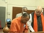 Yogi Adityanath filing the nomination on Friday as Union minister Amit Shah accompanied him to the district collectorate office.