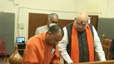 Yogi Adityanath filing the nomination on Friday as Union minister Amit Shah accompanied him to the district collectorate office.