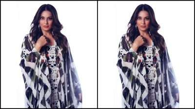 Bipasha paired a black and white slip-in bodycon dress with one thigh high slit with a monochrome tie and dye satin throw. (Instagram/@bipashabasu)