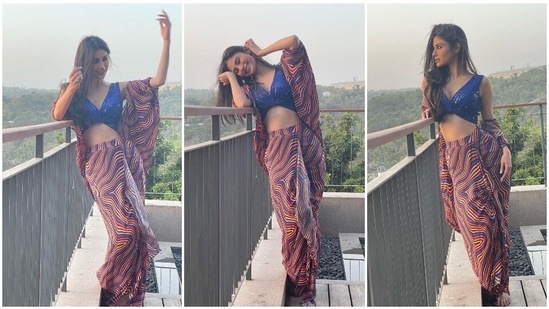 Newlywed bride Mouni Roy, who tied the knot with Dubai-based Suraj Nambiar last week, recently dropped some stunning pictures of herself in a blue sequins bralette, a pleated printed skirt and a cape of the same print as her skirt.(Instagram/imouniroy)