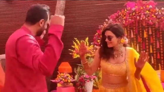 Karishma Tanna and Varun Bangera dance together at their mehendi ceremony.