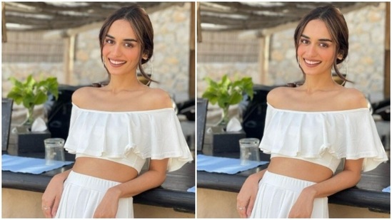 Manushi paired an off-shoulder cropped top with a pair of white trousers with comfy wide legs. Manushi's top came with frills around the neckline.(Instagram/@manushi_chhillar)
