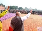 Union Home Minister Amit Shah waves to the Bharatiya Janata Party (BJP) supporters during a public meeting at Atrauli, in Aligarh on Wednesday. (ANI)
