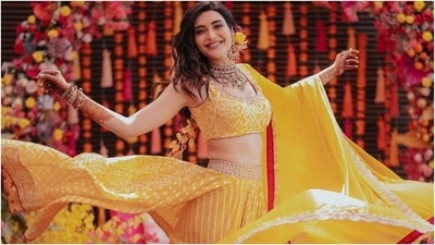 Karishma shined bright in a mustard yellow bandhani printed lehenga set for her Mehendi ceremony. The stars ensemble is from the shelves of designer Punit Balana's clothing label's wedding collection. It is the epitome of elegance and comes replete with intricate details. (Instagram/@karishmaktanna)