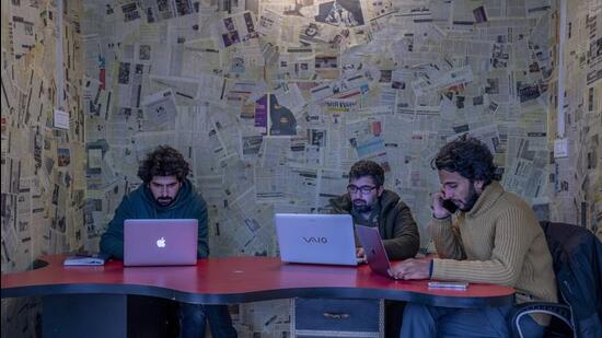 FILE- Fahad Shah, right, editor-in-chief of Kashmir Walla, works on his computer inside the newsroom at his office in Srinagar, Indian controlled Kashmir, Friday, Jan. 21, 2022. Police in Indian-controlled Kashmir have arrested Shah, a young journalist on accusations of publishing "anti-national content," police said, in a widening crackdown against media in the disputed region. (AP Photo/Dar Yasin, File) (AP)