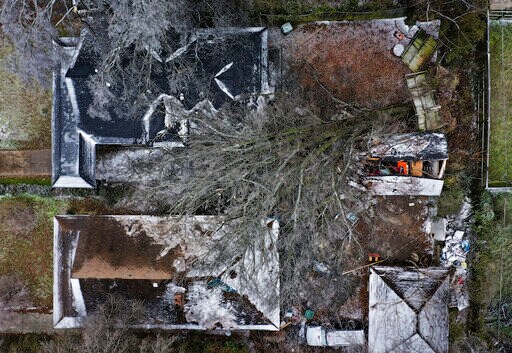 An ice-covered fallen tree covers the yards of two house of Memphis. More than 120,000 customers were without power Friday afternoon in Shelby County, according to poweroutage.us, which tracks utility reports (AP) An ice-covered fallen tree covers the yards of two house of Memphis. More than 120,000 customers were without power Friday afternoon in Shelby County, according to poweroutage.us, which tracks utility reports (AP)