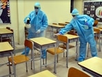 In picture - Workers sanitising a classroom at a school ahead of its reopening in Gurugram on Monday.(PTI) In picture - Workers sanitising a classroom at a school ahead of its reopening in Gurugram on Monday.(PTI)