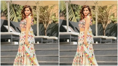 Aamna's blouse had a knot detail in the back with multicolour tassel details. Aamna completed her look with a satin blush pink dupatta with multicolour tassel details at the sides. (Instagram/@aamnasharifofficial)