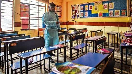 A worker sanitises a classroom at Vidya Bal Bhawan Senior Secondary School in Mayur Vihar, a day before schools in Delhi reopen for students in classes 9 and above.&nbsp;(Amal KS/HT photo)