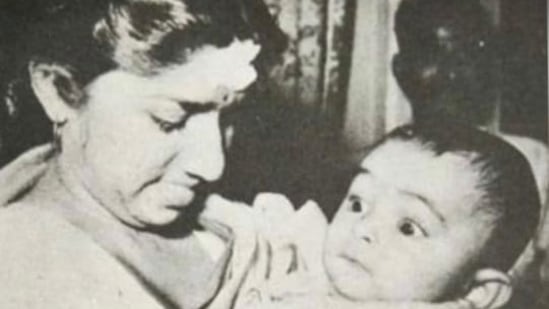 Lata Mangeshkar with Rishi Kapoor in her arms. Neetu Kapoor shared this rare picture while grieving over the death of the legendary singer.&nbsp;