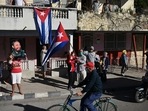 A woman holds a portrait of Cuban leader Fidel Castro, during a protest against the US embargo on Cuba, in Santa Clara, Villa Clara province, Cuba. A woman holds a portrait of Cuban leader Fidel Castro, during a protest against the US embargo on Cuba, in Santa Clara, Villa Clara province, Cuba.