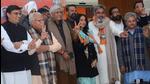 Actors Mahie Gill and Hobby Dhaliwal (both wearing BJP scarves) after joining the party in the presence of Union minister and Punjab BJP election in-charge Gajendra Shekhawat and Haryana chief minister Manohar Lal Khattar in Chandigarh on Monday. (Ravi Kumar/HT)