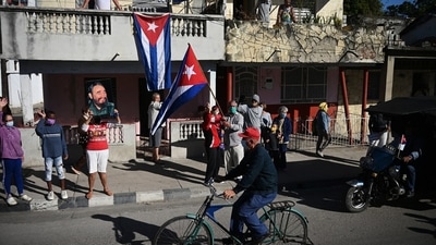 A woman holds a portrait of Cuban leader Fidel Castro, during a protest against the US embargo on Cuba, in Santa Clara, Villa Clara province, Cuba. (AFP)