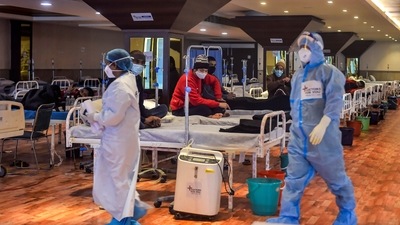 Covid-19 patients undergo treatment inside the Shehnai Banquet Hall, a Covid-19 care facility, in New Delhi. (PTI) Covid-19 patients undergo treatment inside the Shehnai Banquet Hall, a Covid-19 care facility, in New Delhi. (PTI)