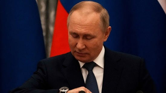 Russian President Vladimir Putin checks his watch before a press conference with French President Emmanuel Macron, in Moscow, Russia,(REUTERS)