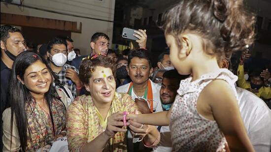 Congress general secretary Priyanka Gandhi Vadra interacts with a child during her door-to-door campaign for the Goa assembly elections, in Panaji on Monday. (PTI)