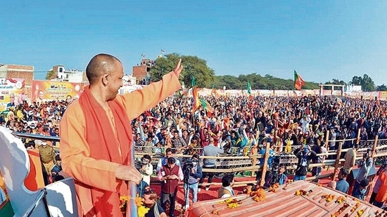 Uttar Pradesh Chief Minister Yogi Adityanath waves towards supporters during the inauguration of BJP's 'Jan Vishwas Yatra' in Mathura ahead of the 2022 UP elections.(PTI Photo)