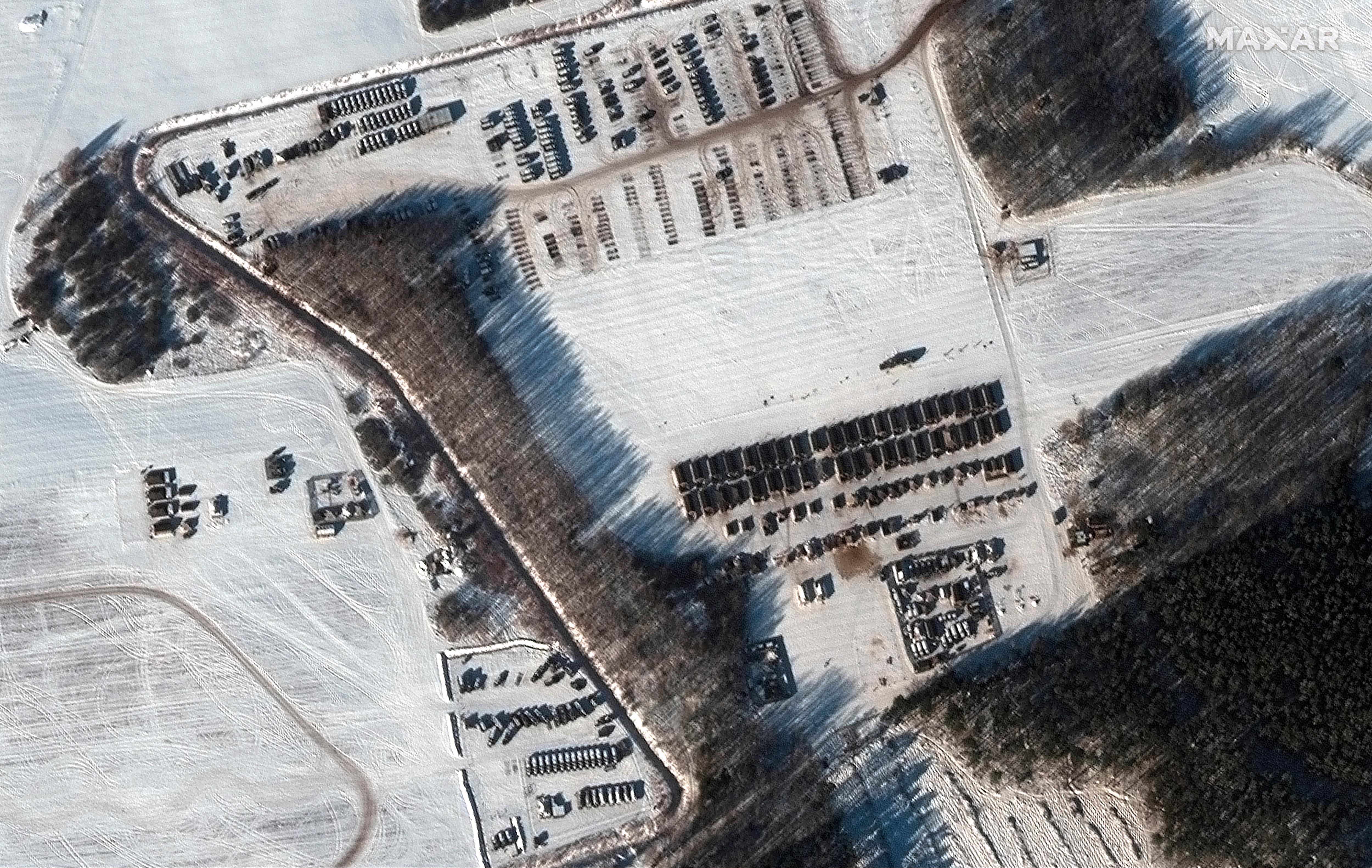 This satellite image shows a troop housing area and vehicle park in Rechitsa, Belarus. (AP via Maxar Tehnologies) This satellite image shows a troop housing area and vehicle park in Rechitsa, Belarus. (AP via Maxar Tehnologies)