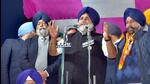 Shiromani Akali Dal president Sukhbir Singh Badal (centre) campaigning for party candidate Maheshinder Singh Grewal (right) at a public meeting in Jawaddi, Ludhiana, on Tuesday evening. (Gurpreet Singh/HT)