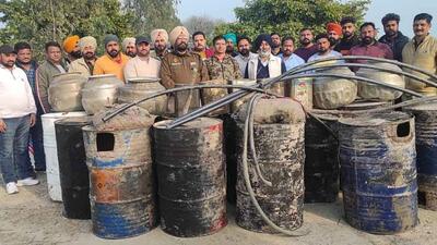 Excise department and police team with the recovered 95,000 litre lahan and 100 bottles of Illicit liquor near Khera Bet village in Ludhiana. (HT Photo) Excise department and police team with the recovered 95,000 litre lahan and 100 bottles of Illicit liquor near Khera Bet village in Ludhiana. (HT Photo)