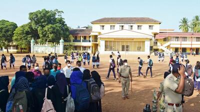 The principal of the college speaking with hijab-clad students. (AFP)