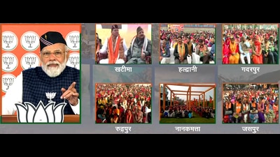 Prime Minister Narendra Modi virtually addresses the 'Vijay Sankalp Sabha' for the people of Udham Singh Nagar and Nainital, as Uttarakhand Chief Minister Pushkar Singh Dhami and Minister of State for Defence and Tourism Ajay Bhatt look on, in New Delhi on Tuesday. (ANI)